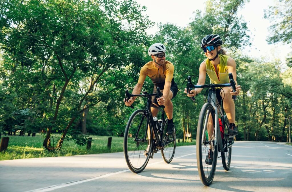 A couple of happy bikers wearing polarized and mirrored sunglasses to protect their eyes and offer comfortable vision.