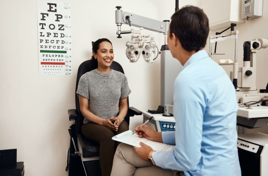smiling patient talking to optometrist about optilight by lumiens